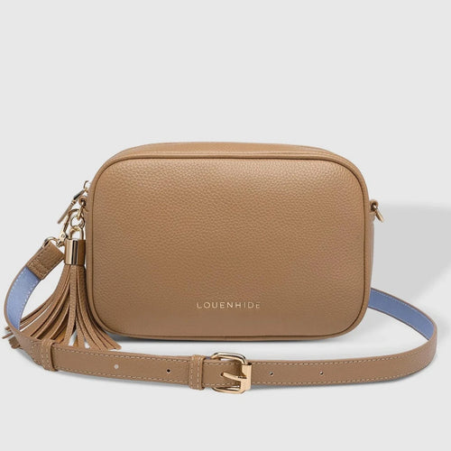 tan colored leather bag with tassel and strap