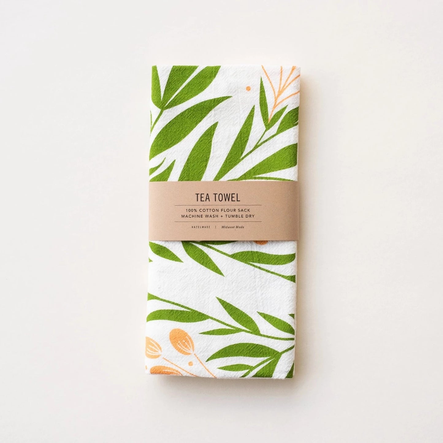 white towel with orange and green floral print