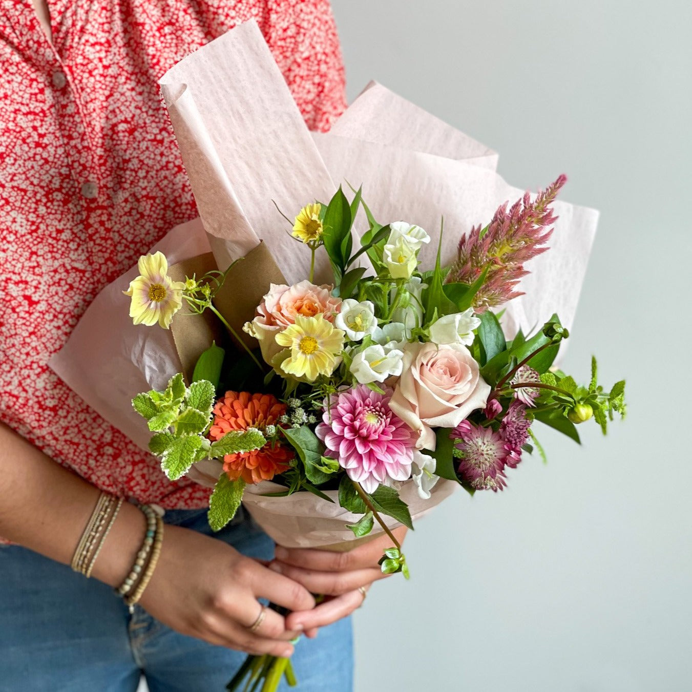 Summer Florals, Fresh Farm Flowers bouquet in hand. Summer Flowers wrapped and ready for delivery