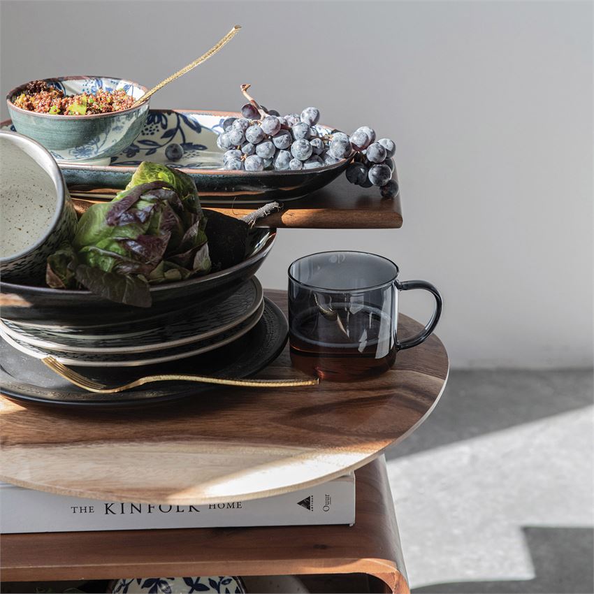 Suar Wood Cutting Board stacked with plates and cups