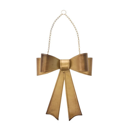 Gold bow-shaped ornament on a white background