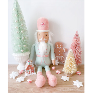 Candy and trees surrounding Nutcracker Stuffed Animal doll