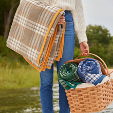 Load image into Gallery viewer, Chappywrap Autumn Plaid Collection displayed in Hand and rolled inside basket held by woman 
