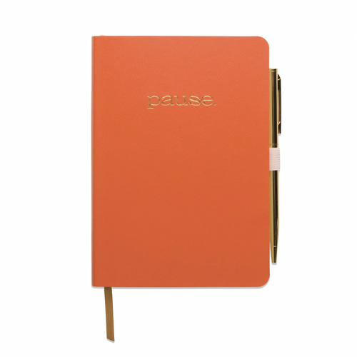 Gratitude Journal - Pause displayed with orange cover and an pen attached 