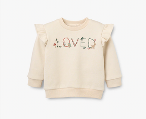 "Loved" written across pullover with florals and animals adorning letters 