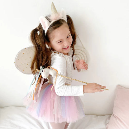 little girl with unicorn costume and magic want
