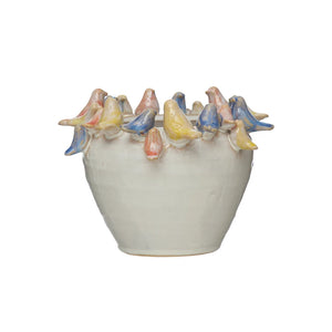 Planter with yellow, blue, and pink birds surrounding top of ceramic planter