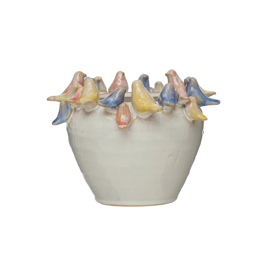 Planter with yellow, blue, and pink birds surrounding top of ceramic planter