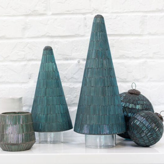 Decorative teal trees and round ornaments on a white brick wall background