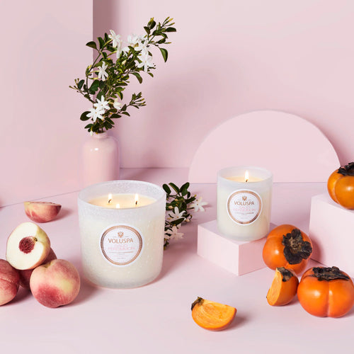 Candles in pink room with peaches and Persimins cut up