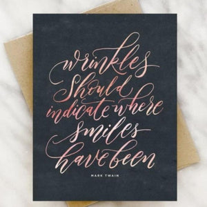 Navy Birthday card with Script "Wrinkles should indicate where smiles have been" —Mark Twain on front, blank interior