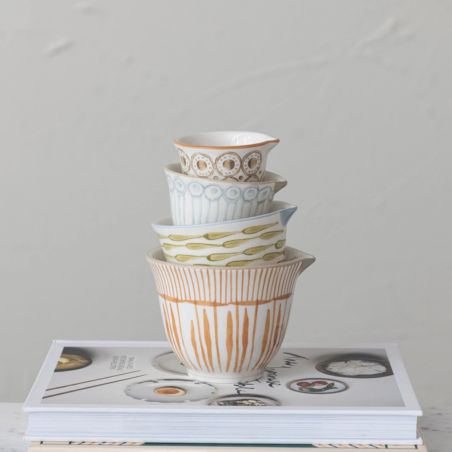 Stack of Mix Matched Measuring cups on Cookbook