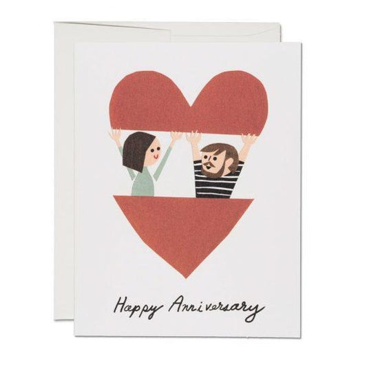 Illustration of couple popping out of a red heart on this anniversary card