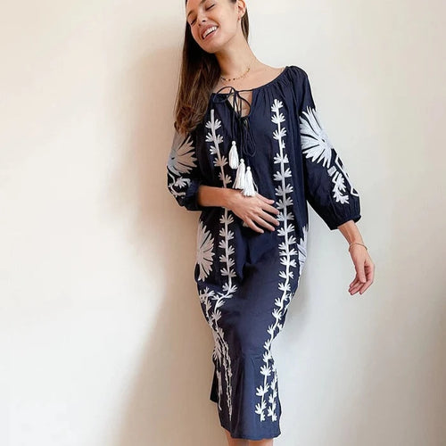 woman wearing navy blue and white embroidered tunic dress