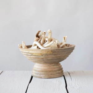 Footed wood bowl with collection of decor pieces insdie