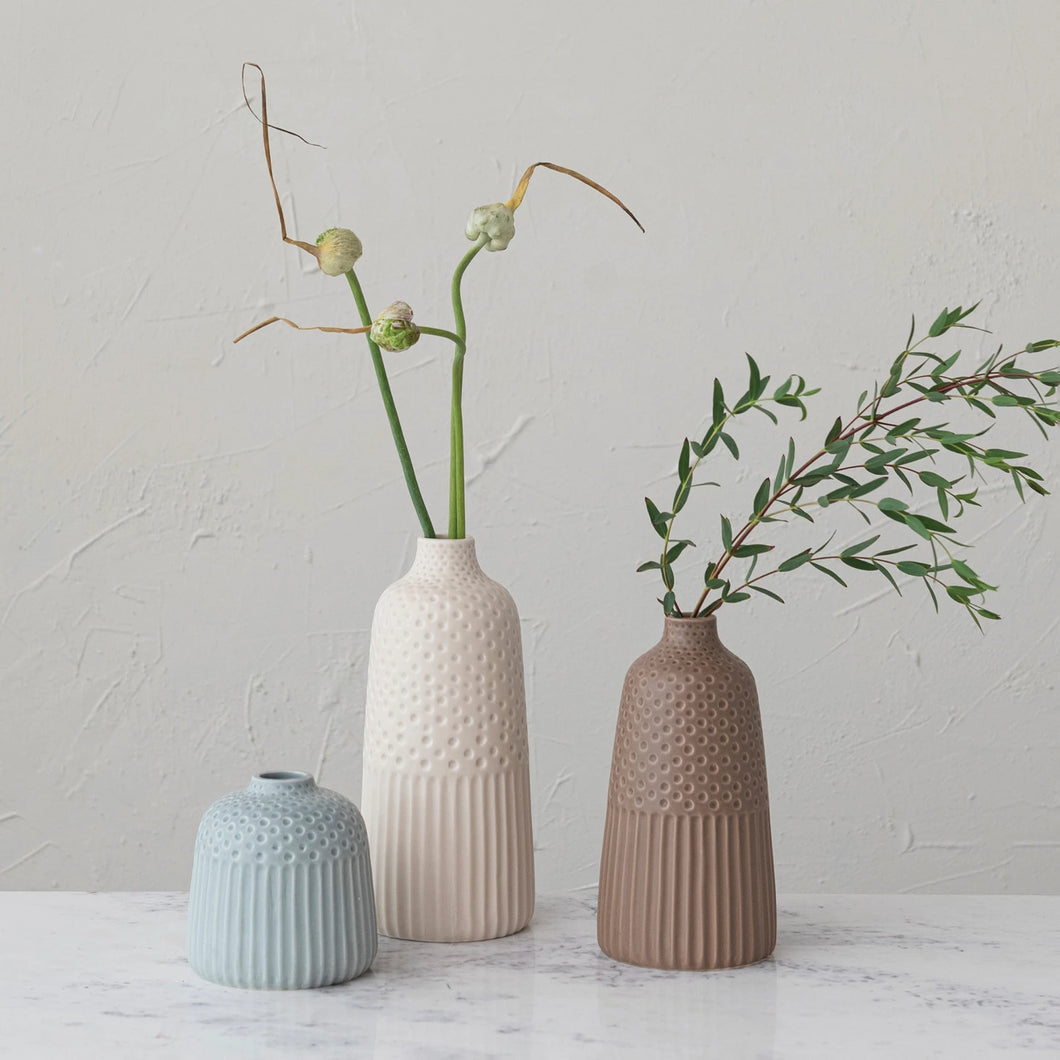 3 sizes of various neutral vases with sprigs of greens