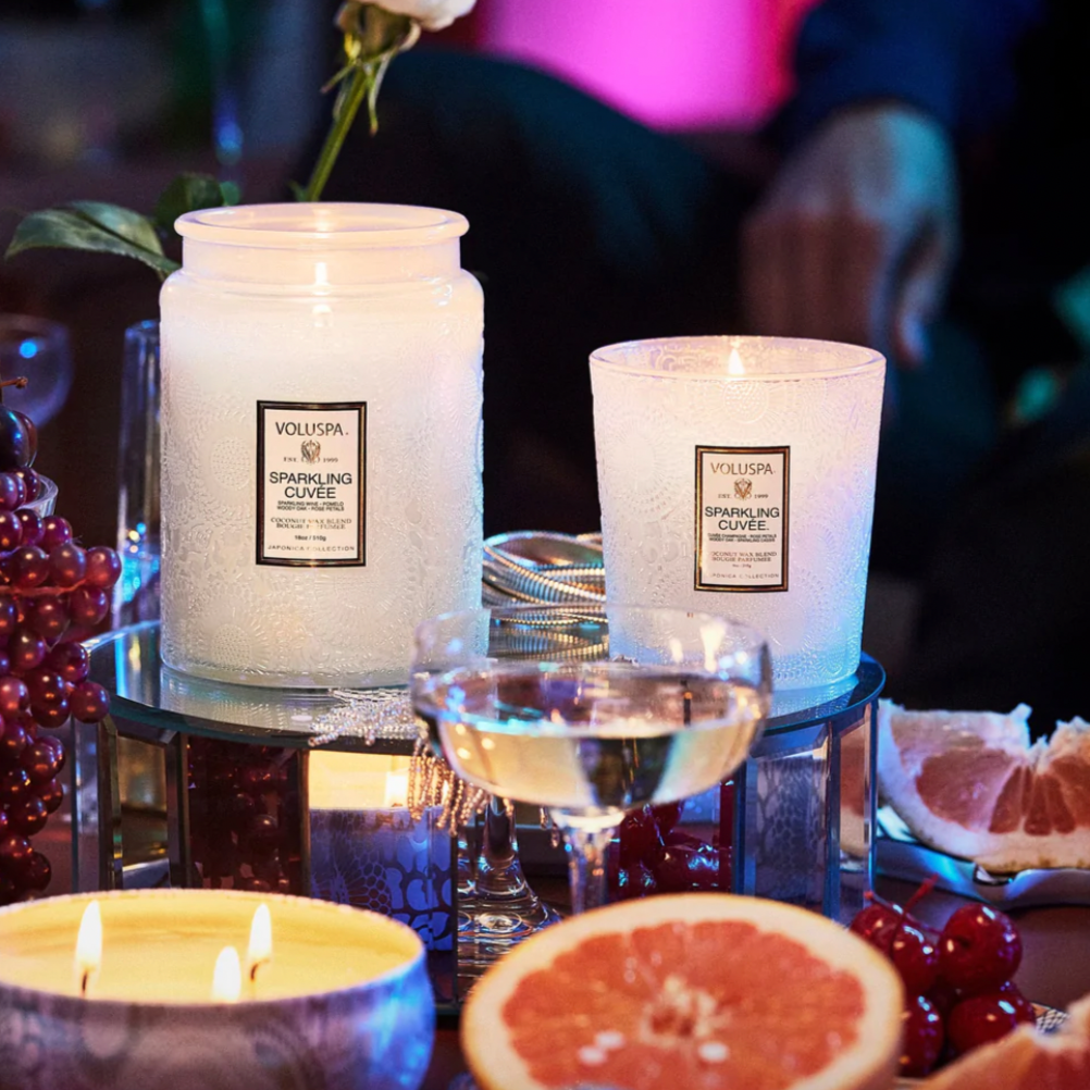 Sparkling Cuvee Jars displayed with fruits and glass of champagne