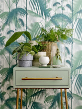 Load image into Gallery viewer, Round Speckled Stoneware Pot on green side table with palm leaf wallpaper
