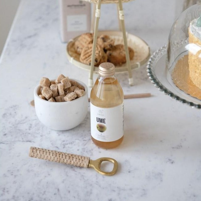 Brass and Bamboo Bottle Opener on granite table with dessert tiered tray