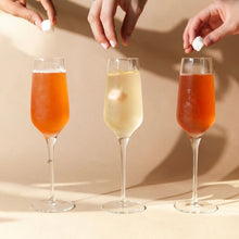Load image into Gallery viewer, Dropping Sugar Cubes into Mimosas
