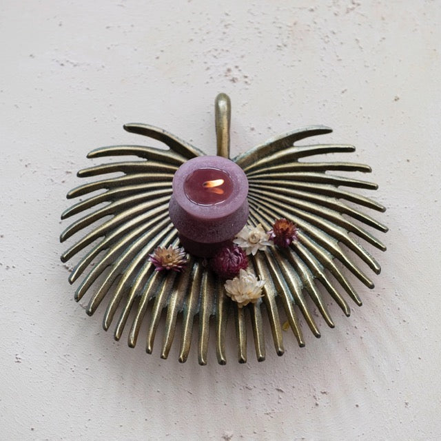 Brass Palm Frond Tray holding purple candle and dry flowers