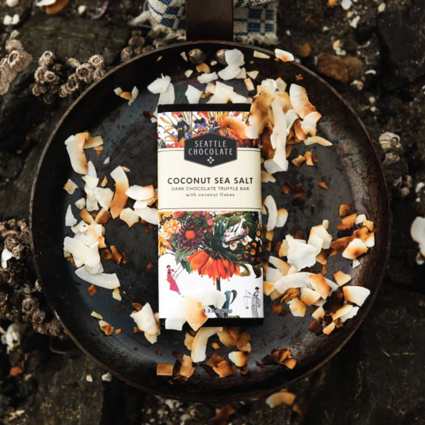 Coconut Sea Salt Truffle Bar with roasted coconut flakes over pan