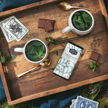 Load image into Gallery viewer, Seattle Chocolate Meltaway Mint Truffle Bar on wooden tray with cards and bowls of fresh mint leaves
